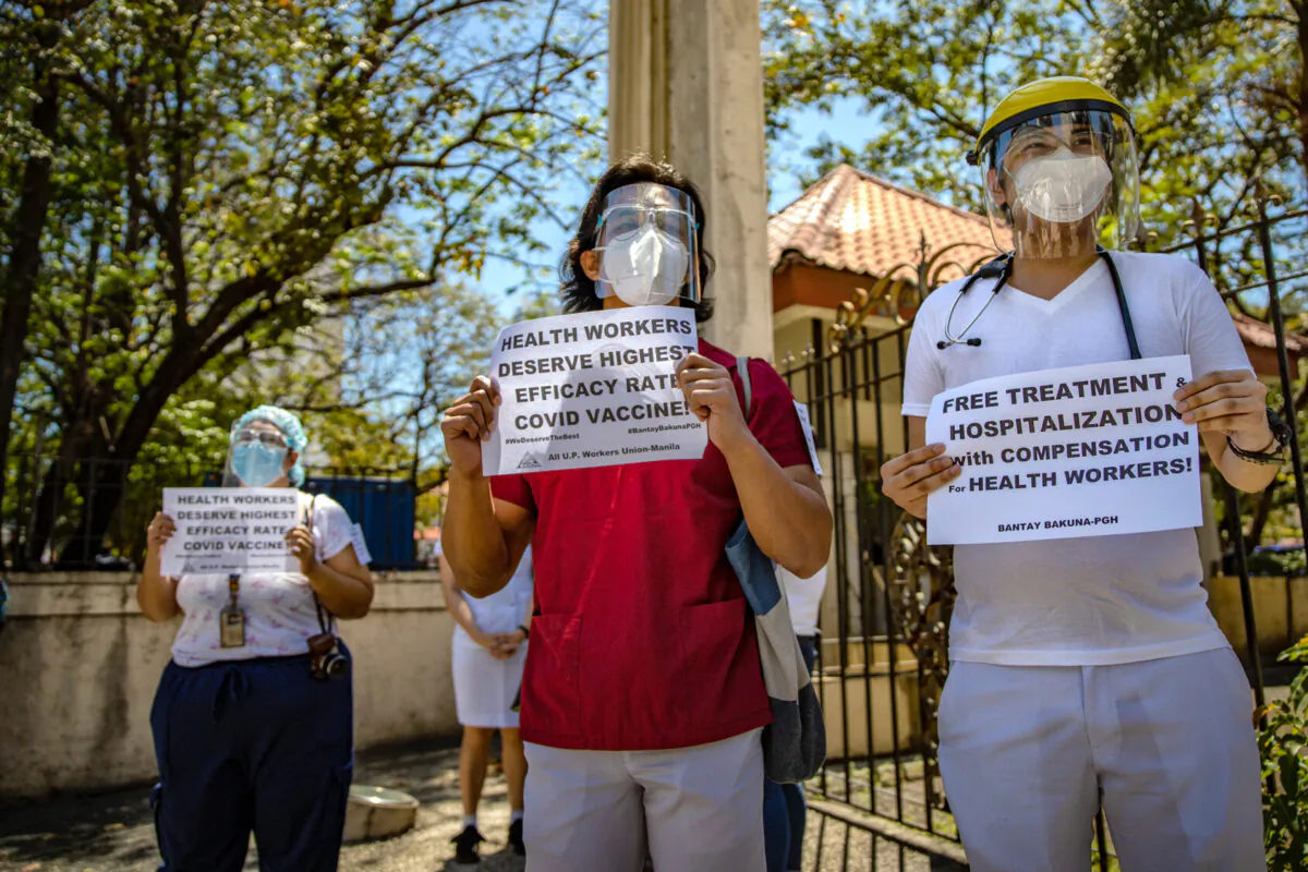 Healthcare workers protest being given Sinovac vaccine instead of Pfizer-BioNTech in Manila, Philippines, on Feb. 26, 2021. (Ezra Acayan/Getty Images)