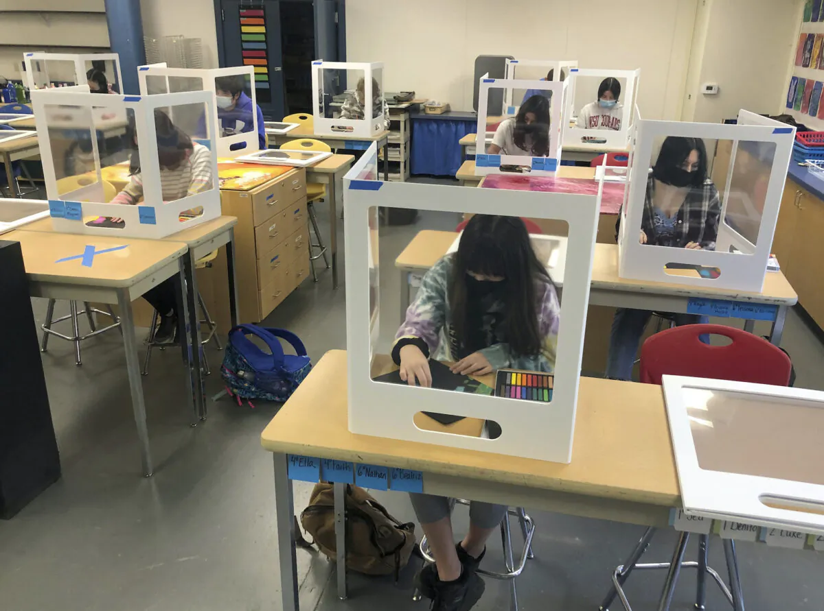 Socially distanced and with protective partitions students work on an art project during class at the Sinaloa Middle School in Novato, Calif., on March 2, 2021. (Haven Daley/AP)