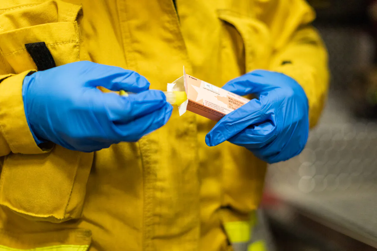 A firefighter displays Narcan, a lifesaving medication used to reverse opioid overdoses, on Feb. 26, 2021. (John Fredricks/The Epoch Times)