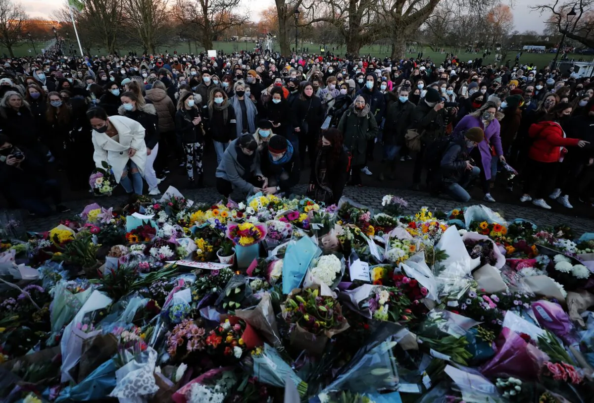 People gather, at the band stand in Clapham Common, in memory of Sarah Everard, after an official vigil was cancelled, in London, on March 13, 2021. (Frank Augstein/AP Photo)