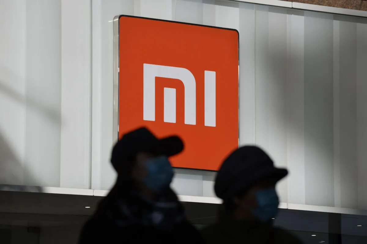 Two women walk past a Xiaomi store in Beijing on Jan. 15, 2021. (Greg baker/AFP via Getty Images)