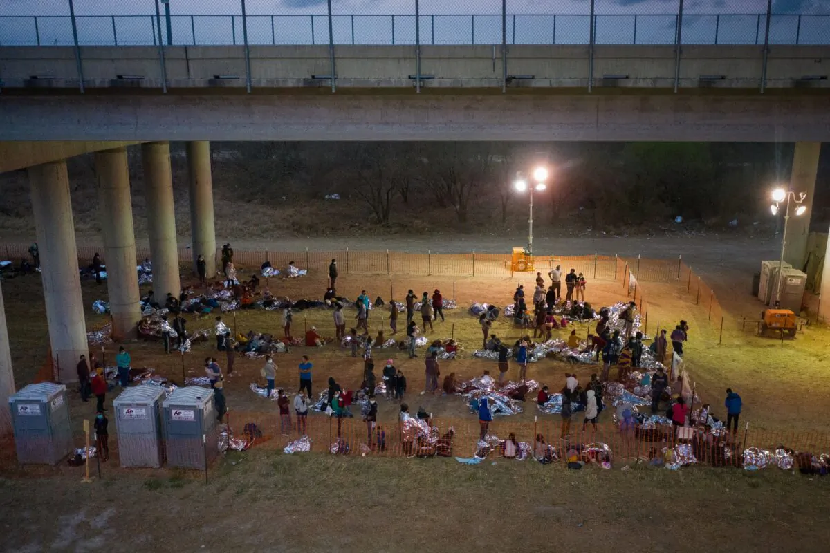 Illegal immigrants from Central America in a makeshift U.S. Customs and Border Protection processing center under the Anzalduas International Bridge after crossing the Rio Grande into the United States from Mexico in Granjeno, Texas, on March 12, 2021. (Adrees Latif/Reuters)