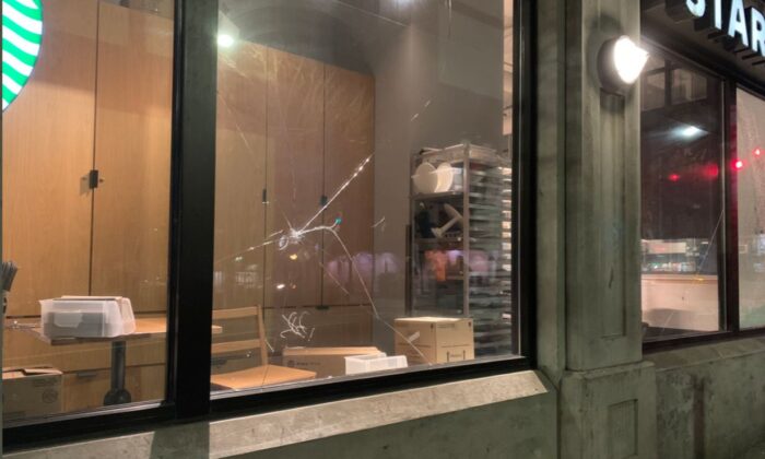 A Starbucks window is smashed during riots and protests marking the one-year anniversary of Breonna Taylor’s death, in Seattle, Wash., on March 13, 2021. (Seattle Police Department)