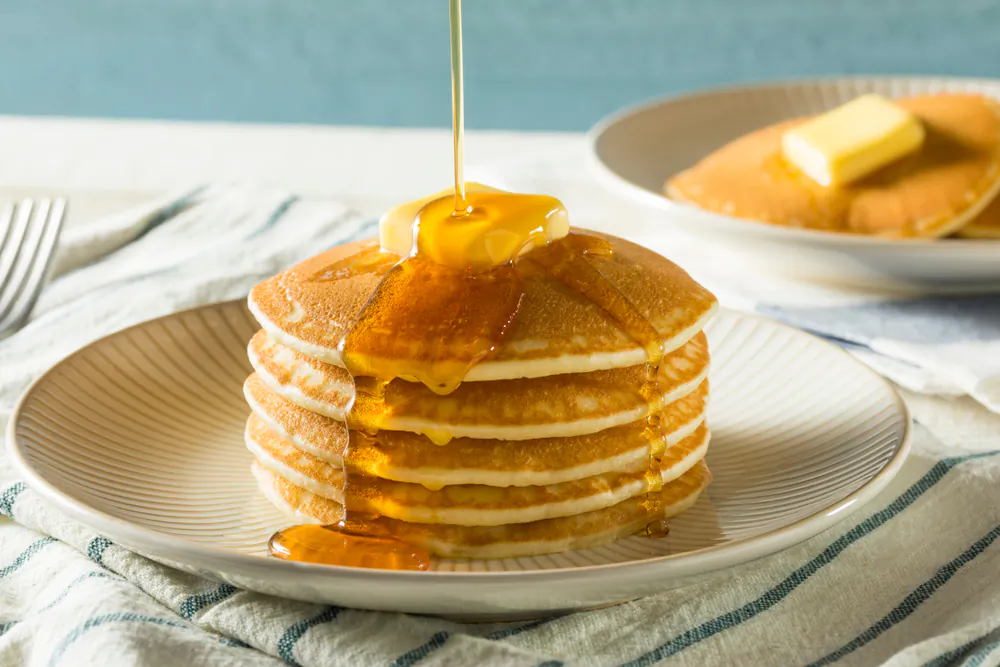 My daughters call Jim's homemade syrup “Pop's Sauce,” after their name for their grandfather, and love to pour it over their pancakes with a generous side of sprinkles on Saturday mornings. (Brent Hofacker/Shutterstock)