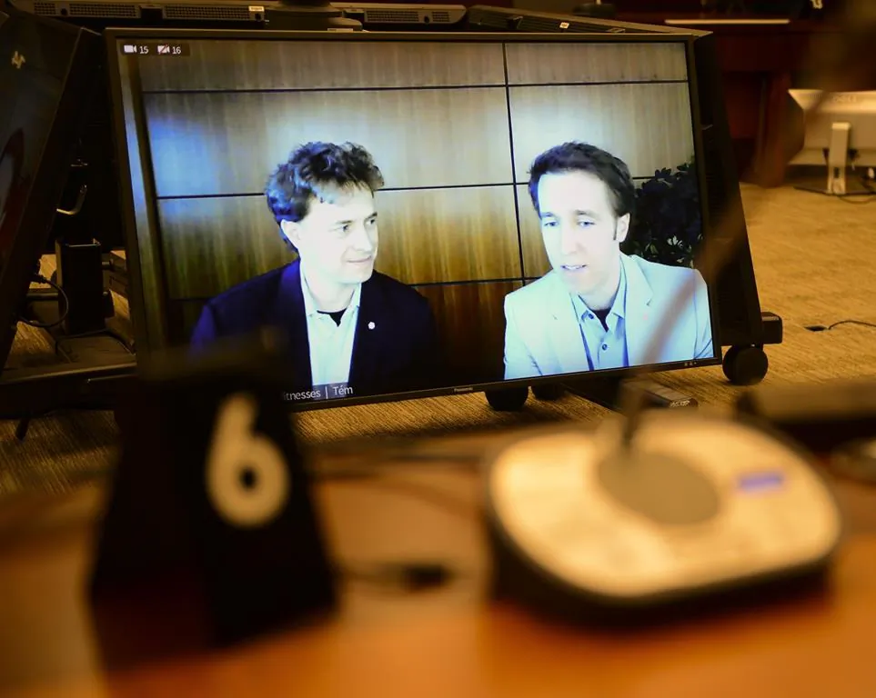 Marc Kielburger (L) and Craig Kielburger (R) are pictured on CPAC as they appear as witnesses via videoconference during a House of Commons finance committee in Ottawa on July 28, 2020. (Sean Kilpatrick/The Canadian Press)