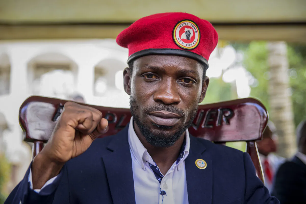 Opposition presidential challenger Bobi Wine, whose real name is Kyagulanyi Ssentamu, gestures as he speaks to the media outside his house after government soldiers withdrew from it, in Magere, near Kampala, in Uganda, on Jan. 26, 2021. (Nicholas Bamulanzeki, File/AP Photo)