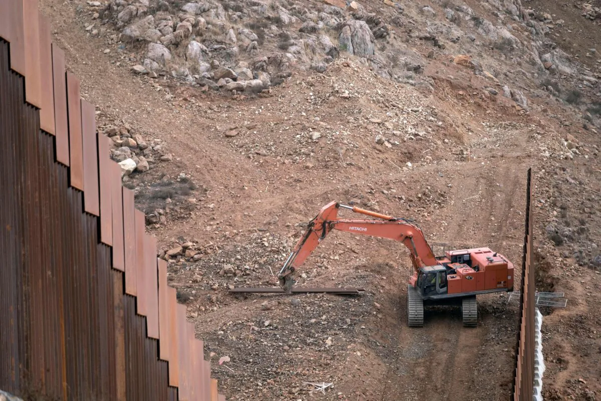 Construction crews work on a new section of the U.S.-Mexico border fencing at El Nido de las Aguilas, eastern Tijuana, Baja California state, Mexico, on Jan. 20, 2021. (Guillermo Arias/AFP via Getty Images)