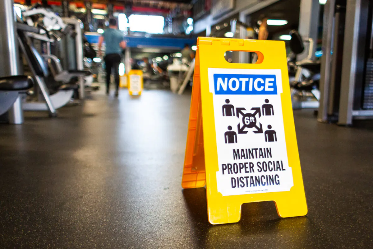A sign on the floor of World Gym Fitness Center in Tujunga, Calif., on Jan. 5, 2021. (John Fredricks/The Epoch Times)