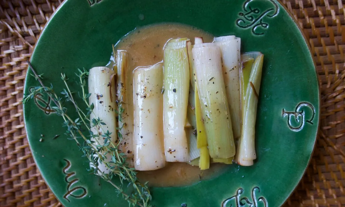 These leeks are gently browned in butter, and then slow-simmered in an aromatic bath of chicken broth and white wine until soft and silky. (Victoria de la Maza)