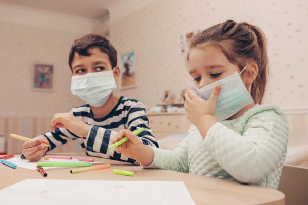 Cute,Children,Boy,And,Girl,In,Medical,Mask,Is,Sitting