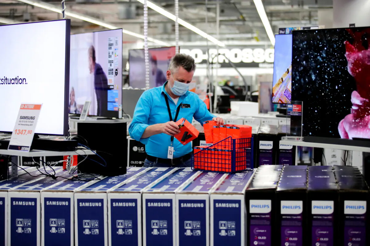An employee wearing a protective mask works at a Saturn electronic store as the coronavirus disease (COVID-19) lockdown measures are eased in Berlin, Germany, on March 11, 2021. (Hannibal Hanschke/Reuters)