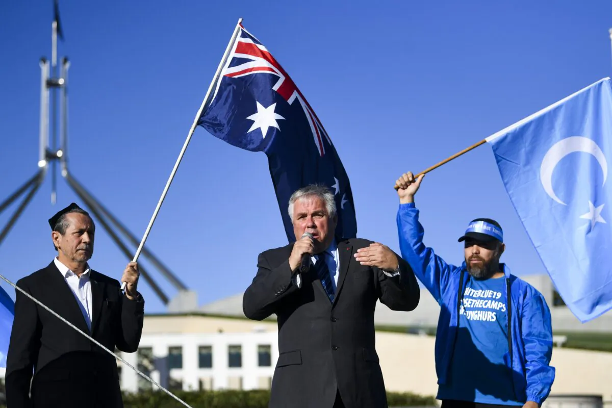 Independent Senator Rex Patrick speaks during a rally for the Uyghur community outside Parliament House in Canberra, Monday, March 15, 2021. (Lukas Coch/AAP)