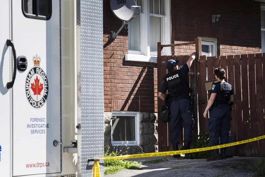 A Durham Regional Police forensics unit is seen in Oshawa, Ont., on July 10, 2018 outside a home where body parts were found in a basement apartment. (Christopher Katsarov/The Canadian Press)