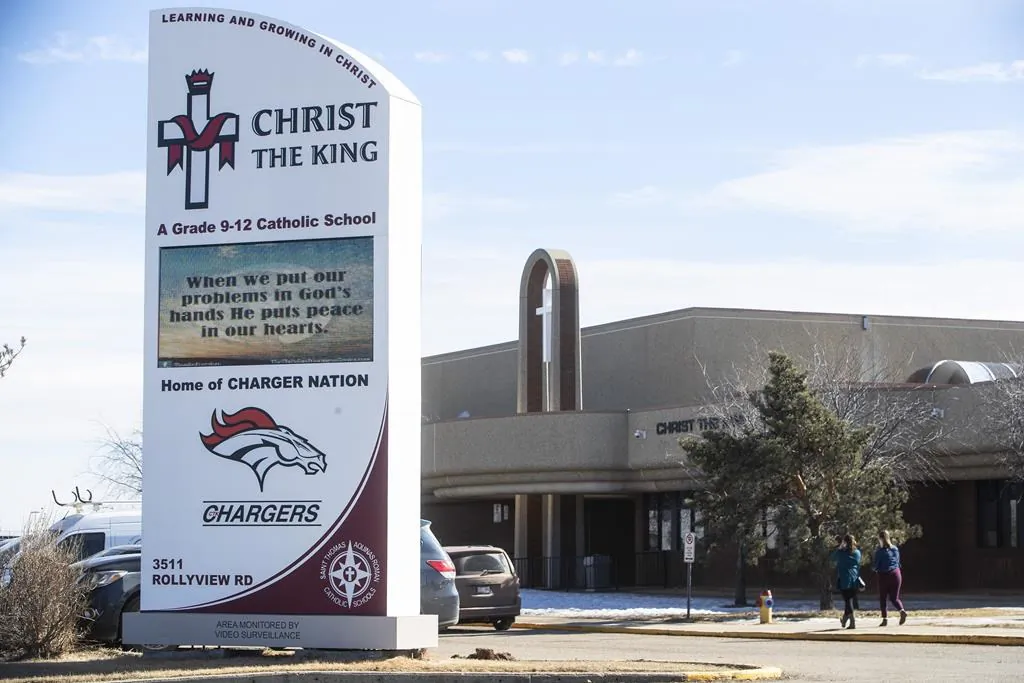 People leave a school after a student was airlifted to hospital after a stabbing at a school , in Leduc Alta, on March 15, 2021. (THE CANADIAN PRESS/Jason Franson)