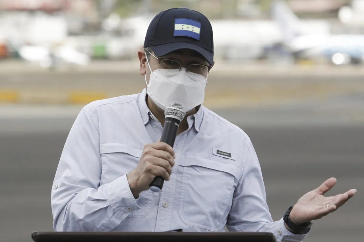 Honduran President Juan Orlando Hernandez during a ceremony at an air base to receive a shipment of the AstraZeneca COVID-19 vaccine via the COVAX program, in Tegucigalpa, Honduras, Saturday, March 13, 2021. (Elmer Martinez/AP Photo)