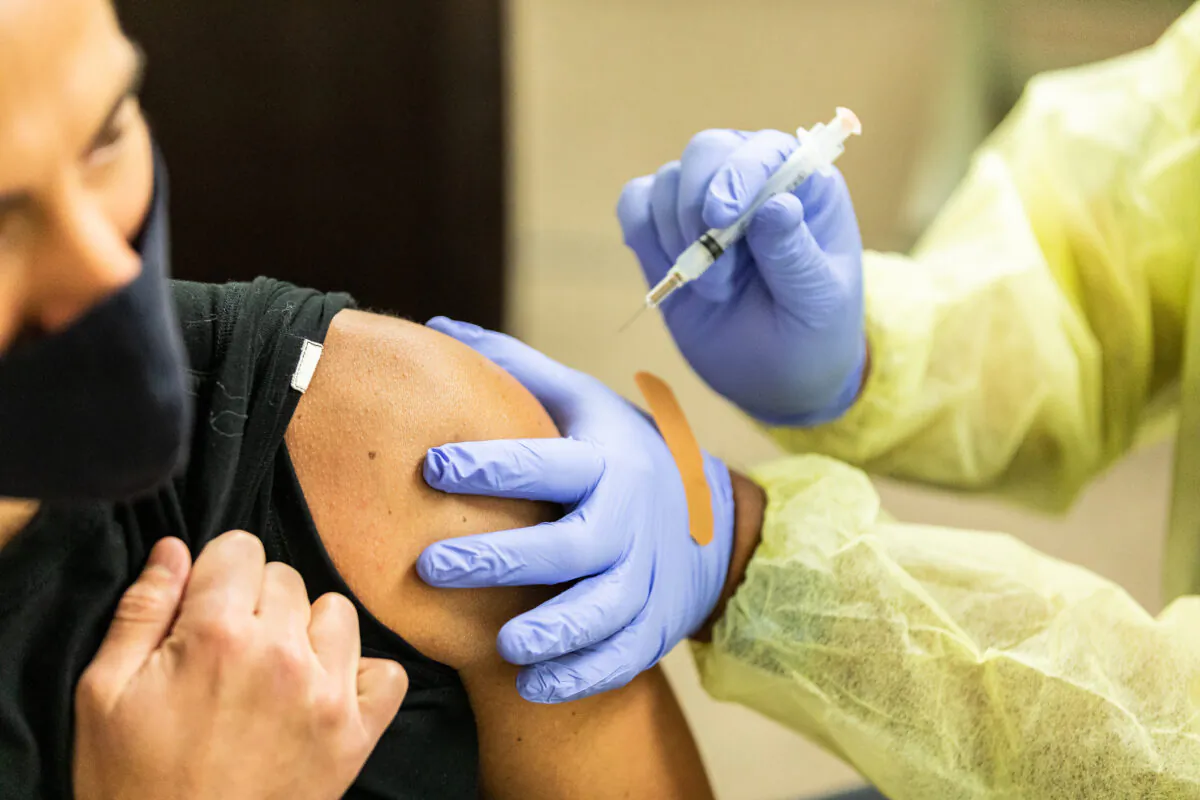 A health care worker prepares the Moderna COVID-19 vaccine at Lestonnac Health Clinic in Orange, Calif., on March 9, 2021. (John Fredricks/The Epoch Times)