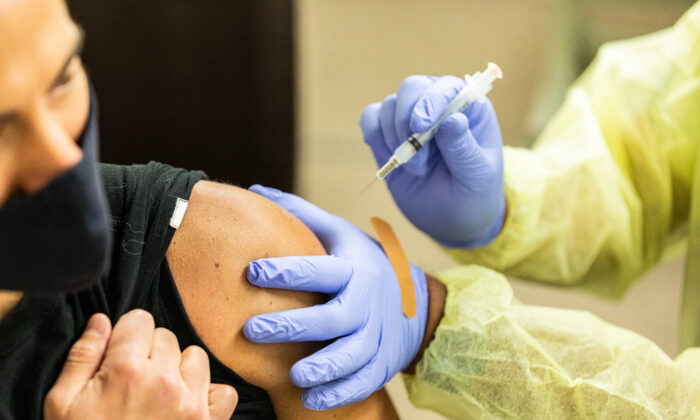 A healthcare worker prepares a COVID-19 vaccine at Lestonnac Health Clinic in Orange, Calif., on March 9, 2021. (John Fredricks/The Epoch Times)