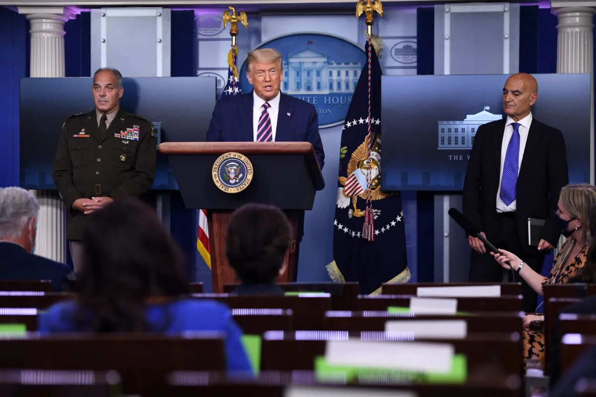 US President Donald Trump holds a press conference, flanked by Army Gen. Gustave Perna (L), who is leading Operation Warp Speed, and Dr. Moncef Slaoui (R), chief adviser to Operation Warp Speed, in the Brady Press Briefing Room at the White House on Sept. 18, 2020. (SAUL LOEB/AFP via Getty Images)