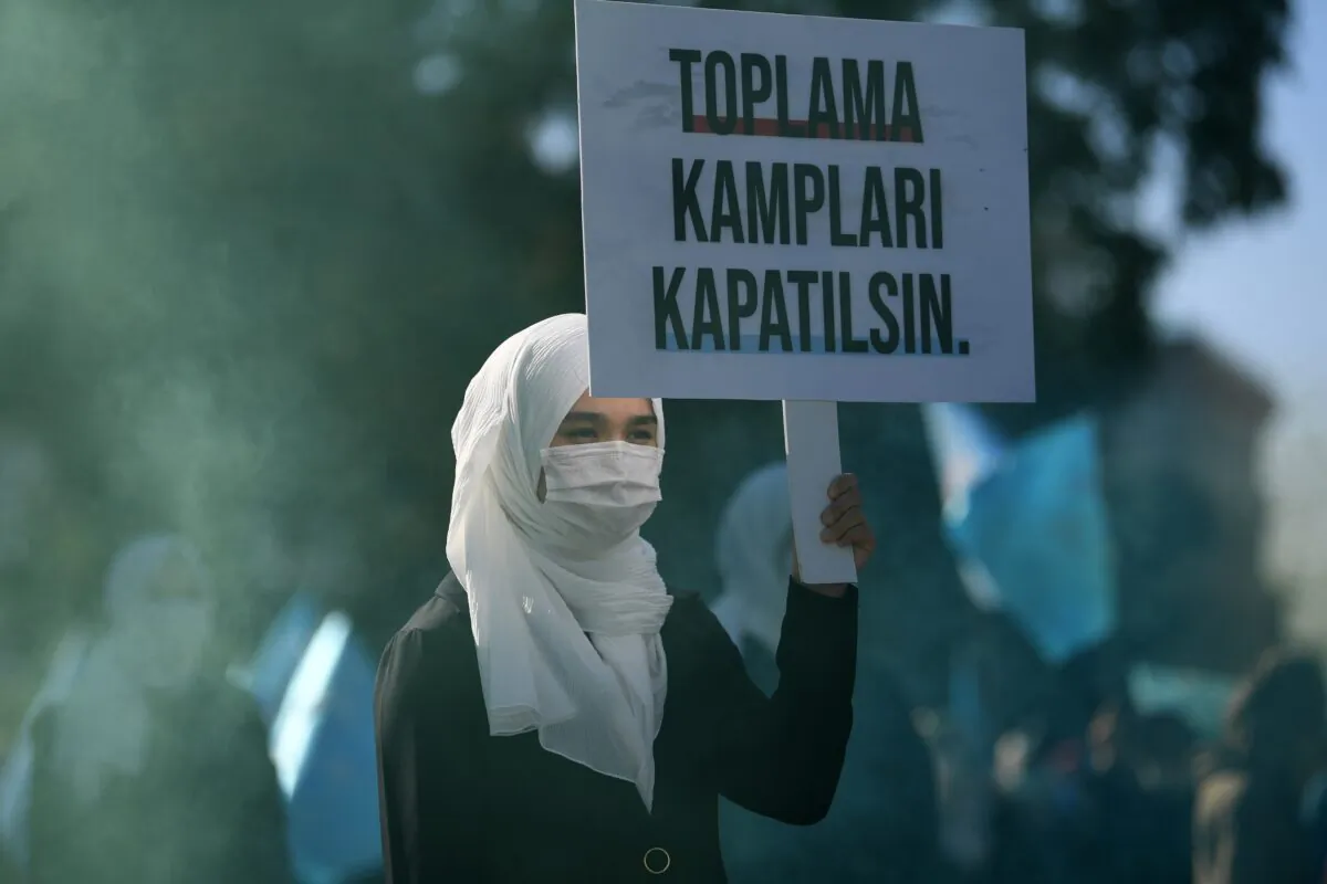 A woman holds a placard reading "Close the camps" during a demonstration by supporters of China's Muslim Uyghur minority against China's Uighur treatment at the Beyazid square in Istanbul, Turkey, on Oct. 1, 2020. (Ozan Kose/AFP via Getty Images)