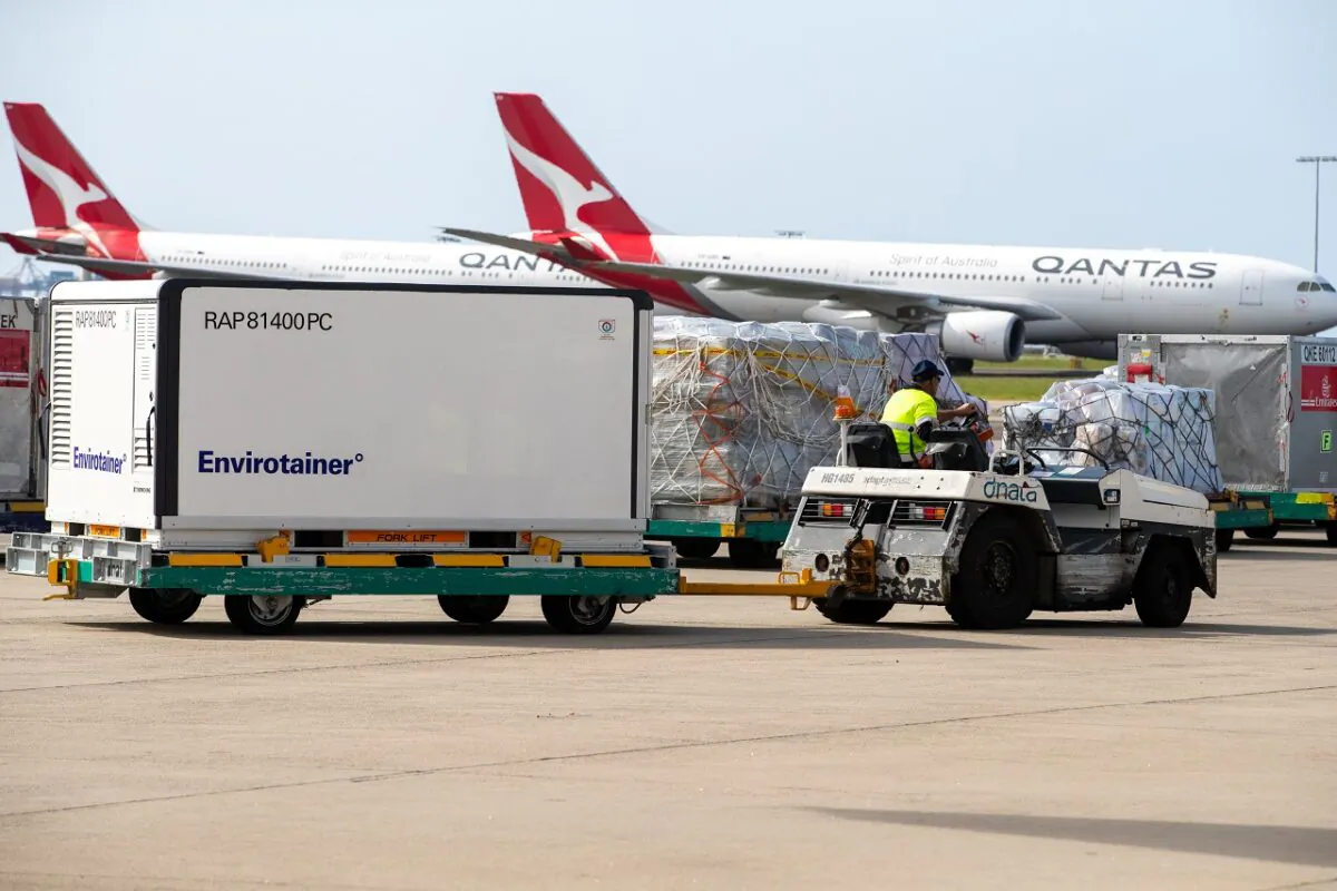Container RAP81400PC  is transported away from the plane at Sydney International airport in Sydney, Australia, on Feb. 28, 2021. (Edwina Pickles - Pool/Getty Images)
