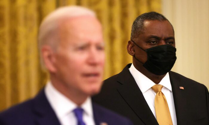 Defense Secretary Lloyd Austin looks on as President Joe Biden speaks, in the White House in Washington on March 8, 2021. (Alex Wong/Getty Images)