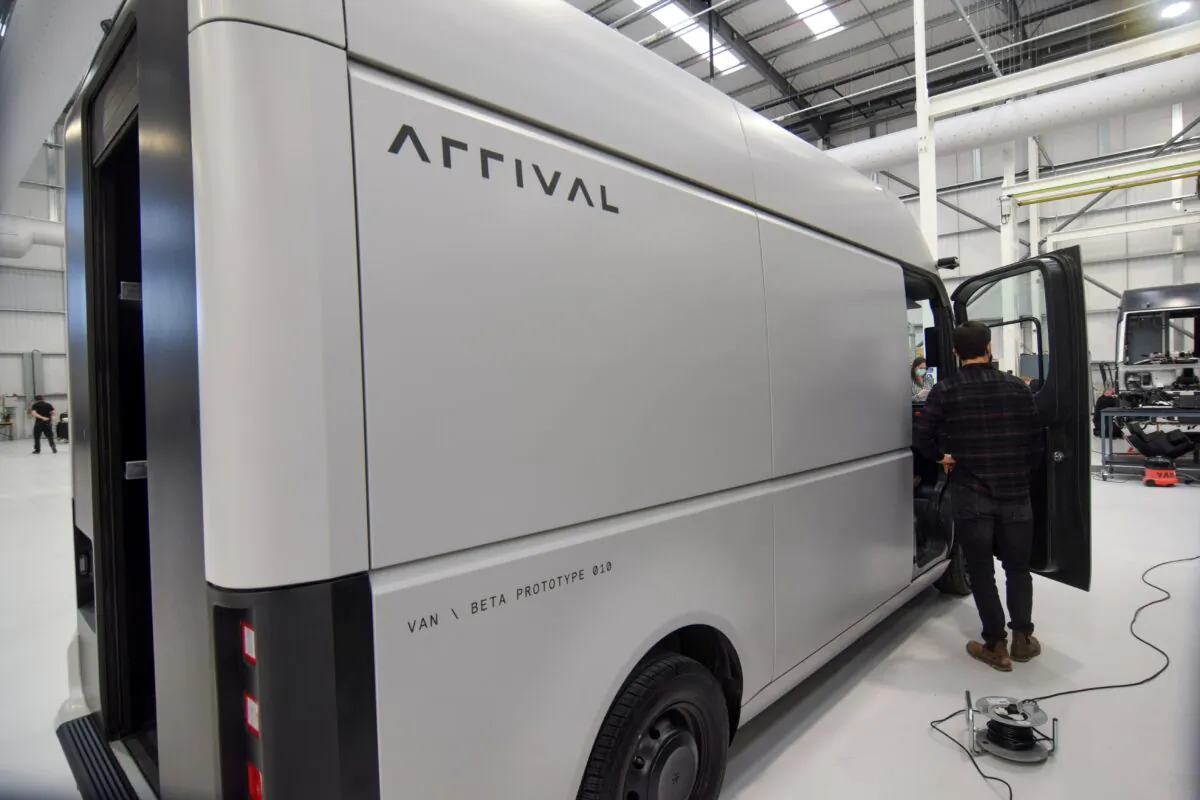 A man stands next to a fully-electric test van, due to go into production in 2022, built by electric van and bus maker Arrival Ltd, that has seen a spike in interest due to soaring e-commerce amid the coronavirus disease (COVID-19) pandemic and looming fossil-fuel vehicle bans, in Banbury, Britain, on Feb. 23, 2021. (Nick Carey/Reuters)