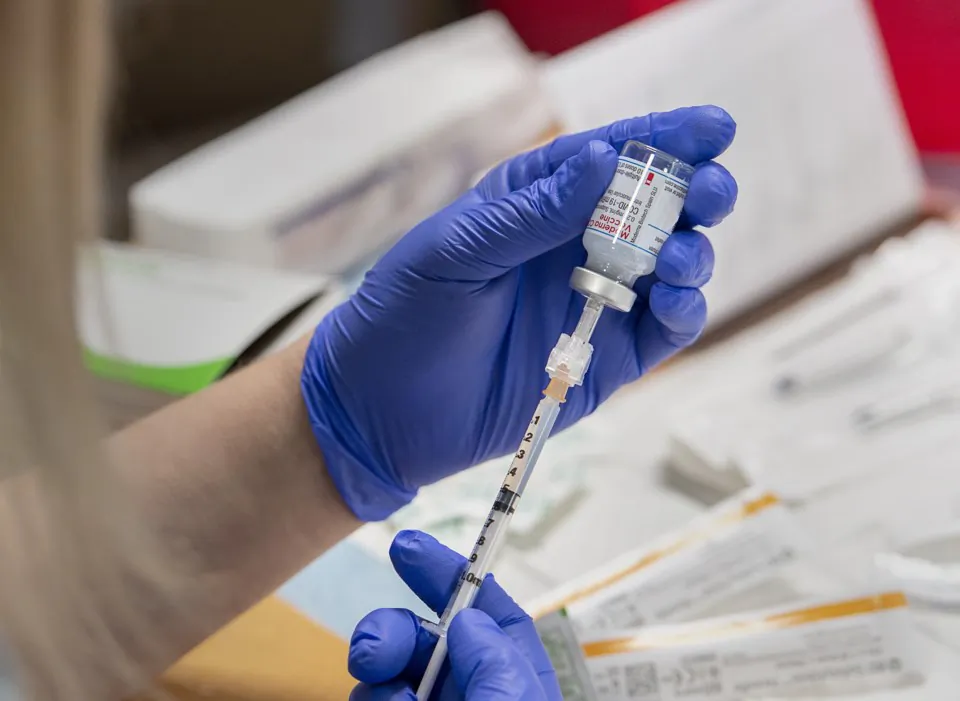 Amanda Parsons, a registered nurse on staff at the Northwood Care facility, prepares a dose of the Moderna vaccine in Halifax on January 11, 2021. (Andrew Vaughan/The Canadian Press) 