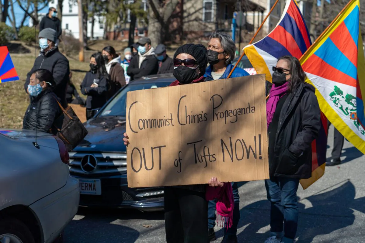 A protester asks Tufts University to close its Confucius Institute, a language training program that the Chinese regime uses to promote communist mentalities, in Somerville, Mass. on March 13, 2021. (Learner Liu/The Epoch Times)