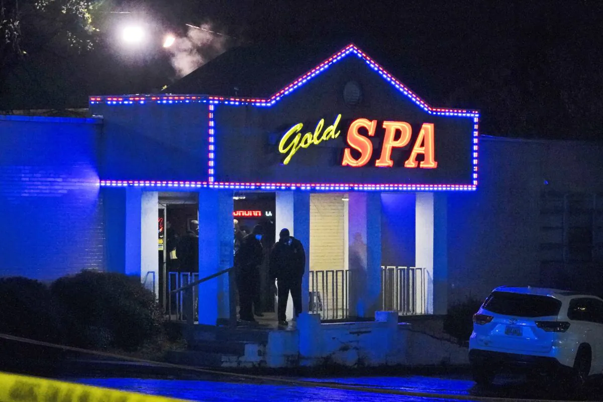 Officials stand in front of a massage parlor after a shooting on Tuesday, in Atlanta, March 16, 2021. (Brynn Anderson/AP Photo)