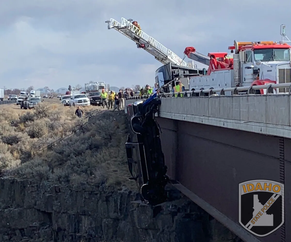 Emergency crews rescue two people after their pickup truck plunged off a bridge, leaving them dangling above a deep gorge in southern Idaho, on March 15, 2021. (Idaho State Police via AP)
