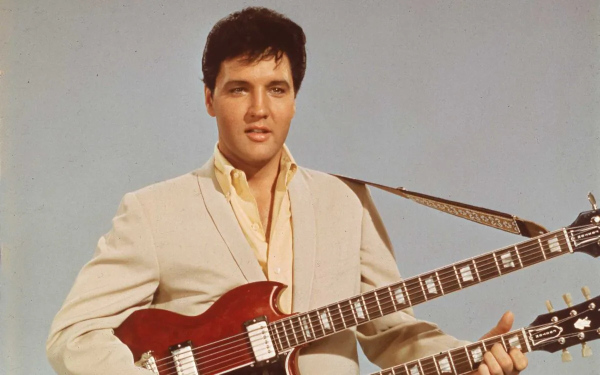 Portrait of American singer and actor Elvis Presley (1935–1977) holding a 1965 Gibson EBS-1250 Double Bass (a combined 6-string and bass guitar), circa 1966. Elvis is seen playing the guitar in his 1966 film, “Spinout.” (Hulton Archive/Getty Images)