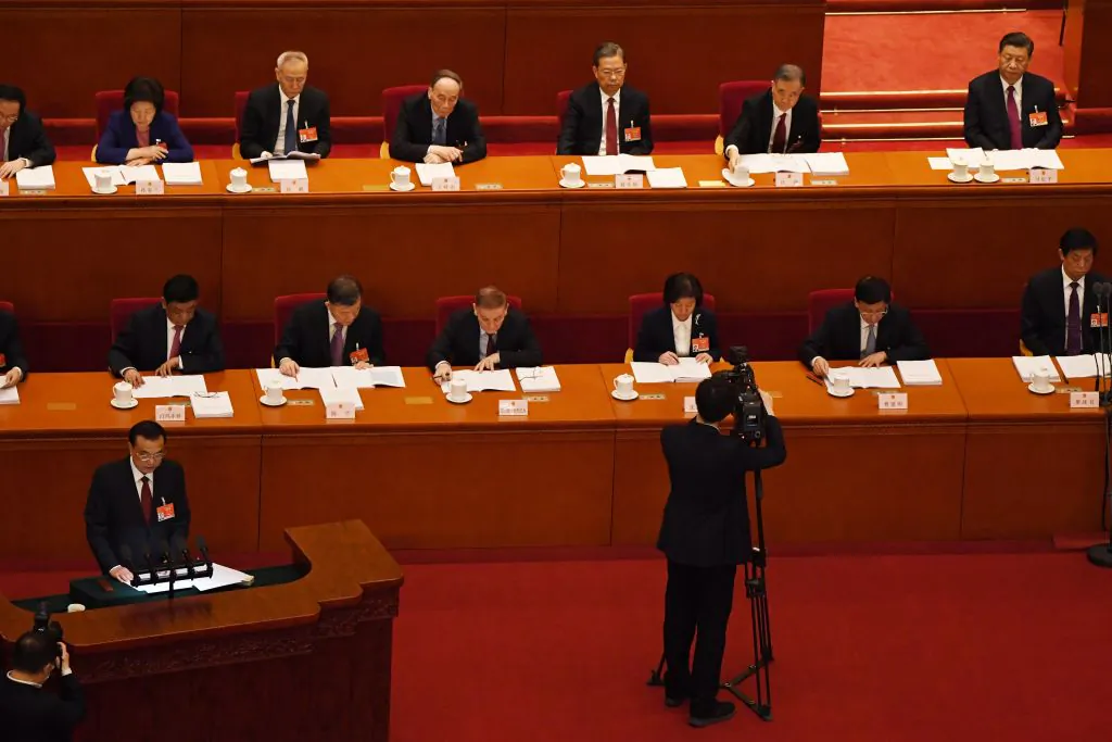 Chinese Premier Li Keqiang (bottom L) reads his work report, proposing "in-depth planning to promote 'Science and Technology Innovation 2030'"during the opening session of the National People's Congress at the Great Hall of the People in Beijing on March 5, 2021. (Leo Ramirez / AFP via Getty Images)