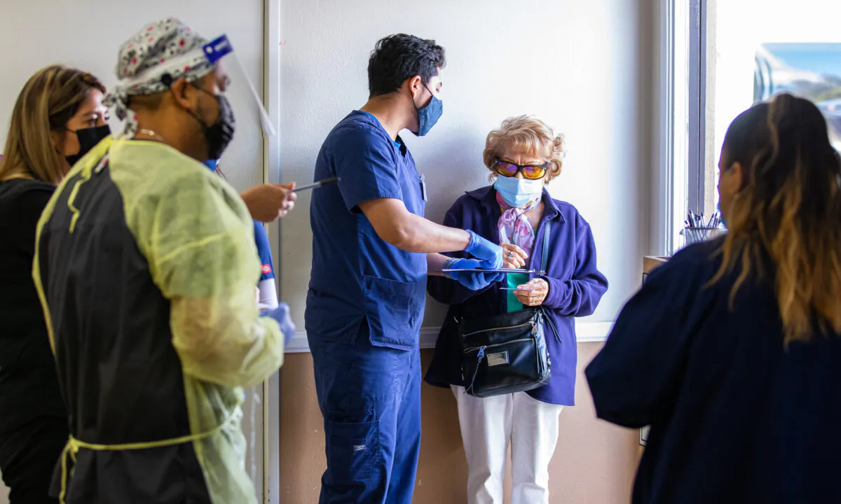 Volunteers at the Lestonnac Free Clinic guide patients through the COVID-19 vaccination process in Orange, Calif., on March 9, 2021. (John Fredricks/The Epoch Times) 