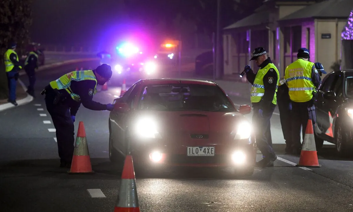 Police in the southern New South Wales (NSW) border city of Albury check cars crossing the state border from Victoria on July 7, 2020 as authorities close the border due to an outbreak of COVID-19 coronavirus in Victoria. (WILLIAM WEST/AFP via Getty Images)