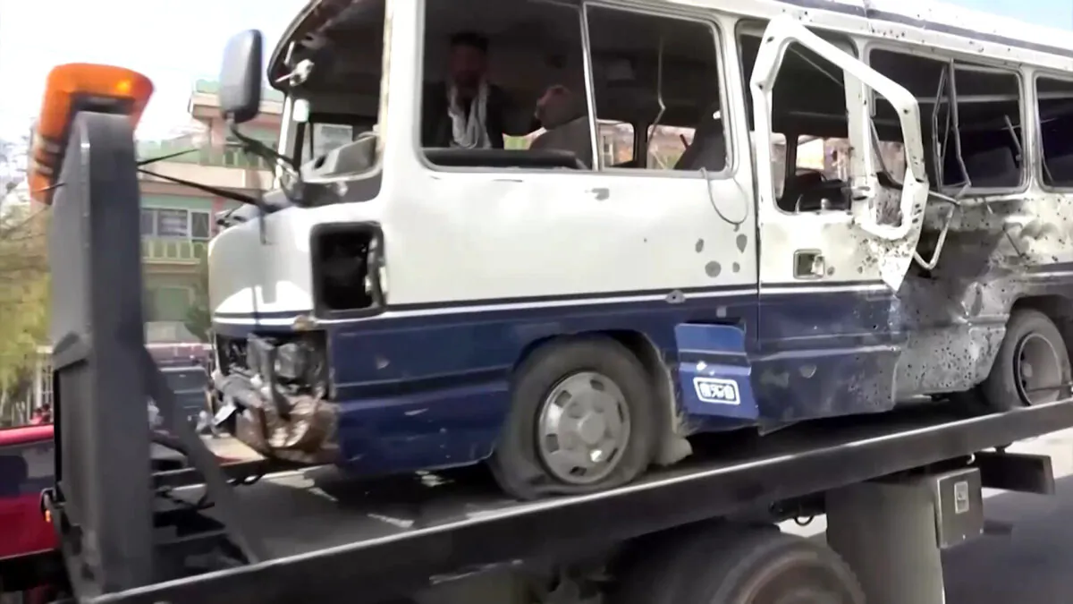 The wreckage of a bus that carried Afghan government employees and was hit by a roadside bomb in Kabul, Afghanistan, on March 18, 2021. (Screenshot via Reuters)