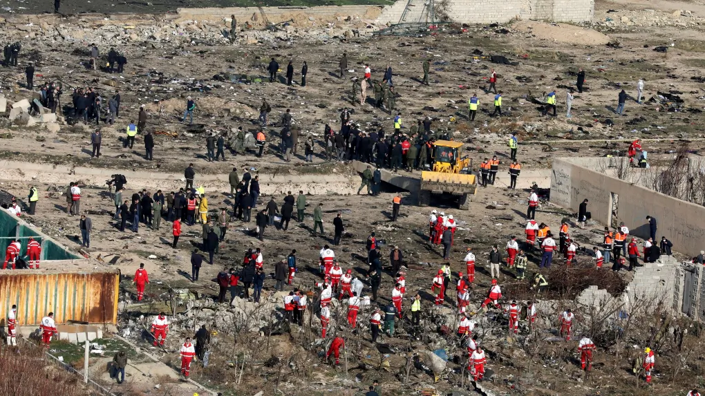 Rescue workers search the scene where an Ukrainian plane crashed in Shahedshahr, southwest of the capital Tehran, Iran, on Jan. 8, 2020. (AP Photo/Ebrahim Noroozi)