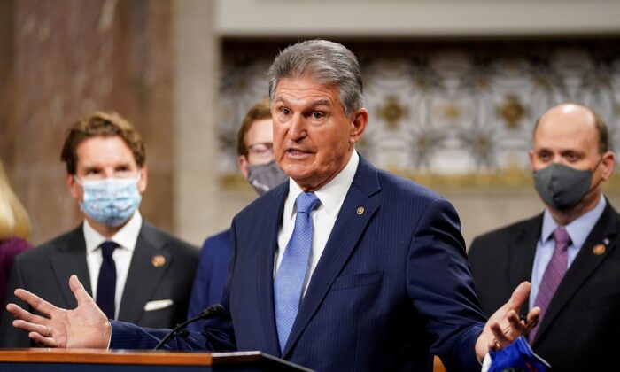 Sen. Joe Manchin (D-W.Va.) removes his mask to speak as bipartisan members of the Senate and House gather to announce a framework for new COVID-19 relief legislation at a news conference on Capitol Hill in Washington on Dec. 1, 2020. (Kevin Lamarque/Reuters)