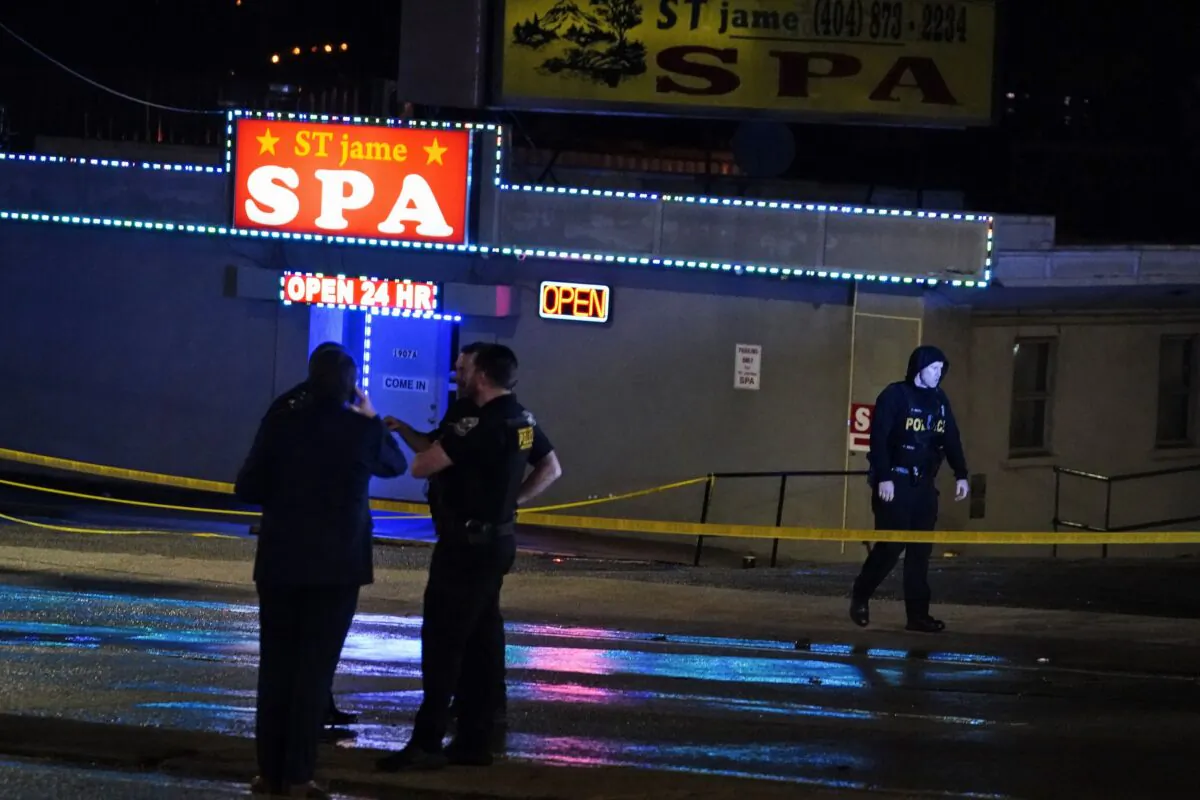 Law enforcement officials confer outside a massage parlor following a shooting in Atlanta on March 16, 2021. (Brynn Anderson/AP Photo)