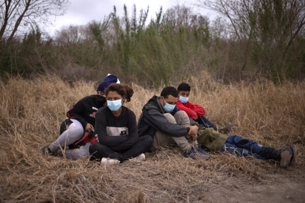 Migrants from Central America await transport after crossing into the U.S. from Mexico on a raft in Penitas