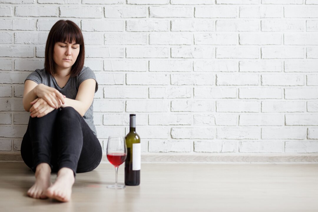 Alcohol can offer a numbing respite from grief but it doesn't truly help us recover from the loss of a loved one. (Di Studio/Shutterstock)