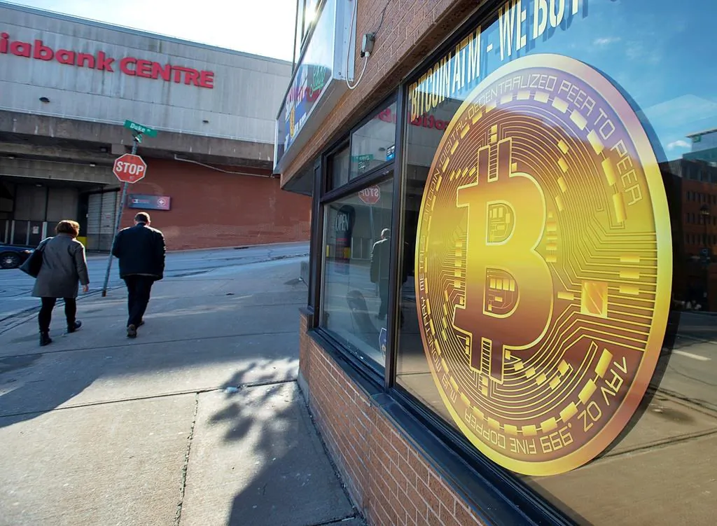 A sign advertises a Bitcoin automated teller machine, ATM, at a shop in Halifax on February 4, 2020. (Andrew Vaughan / The Canadian Press)