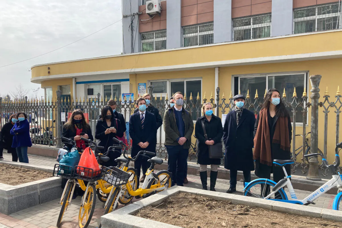 Foreign diplomats gather near a court building in Dandong in northeastern China's Liaoning Province, March 19, 2021. China was expected to open the first trial Friday for Michael Spavor, one of two Canadians who have been held for more than two years in apparent retaliation for Canada's arrest of a senior Chinese telecom executive. (Ken Moritsugu/AP Photo)
