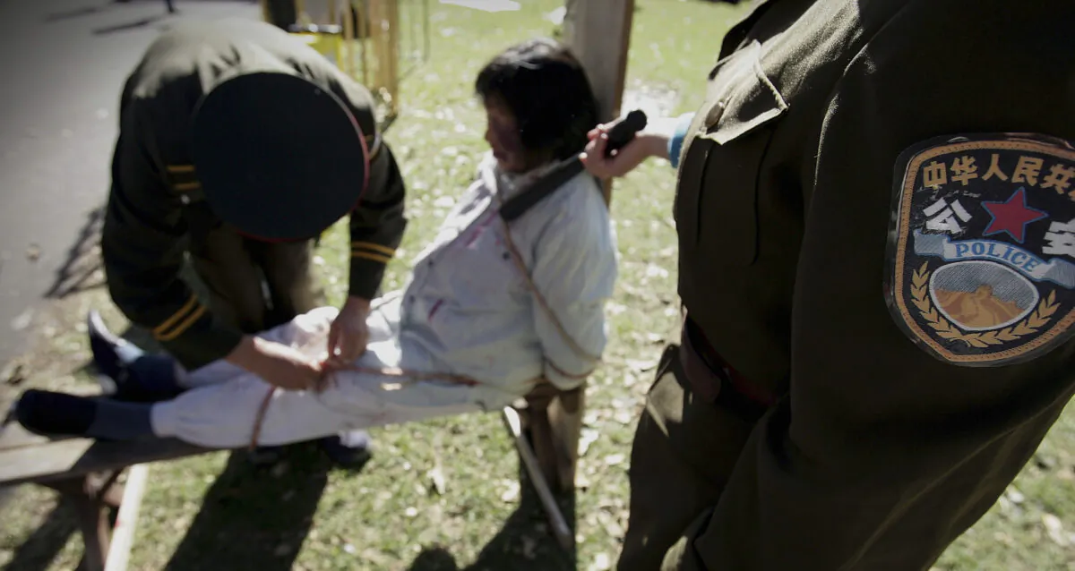 A reenactment of the persecution of Falun Gong practitioners in China, in Sydney Australia on July 20, 2005. (Ian Waldie/Getty Images)