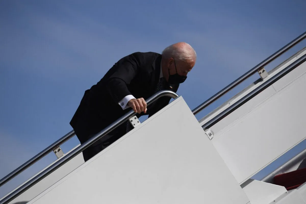 President Joe Biden trips as he boards Air Force One at Joint Base Andrews in Maryland on March 19, 2021. (Eric Baradat/AFP via Getty Images)