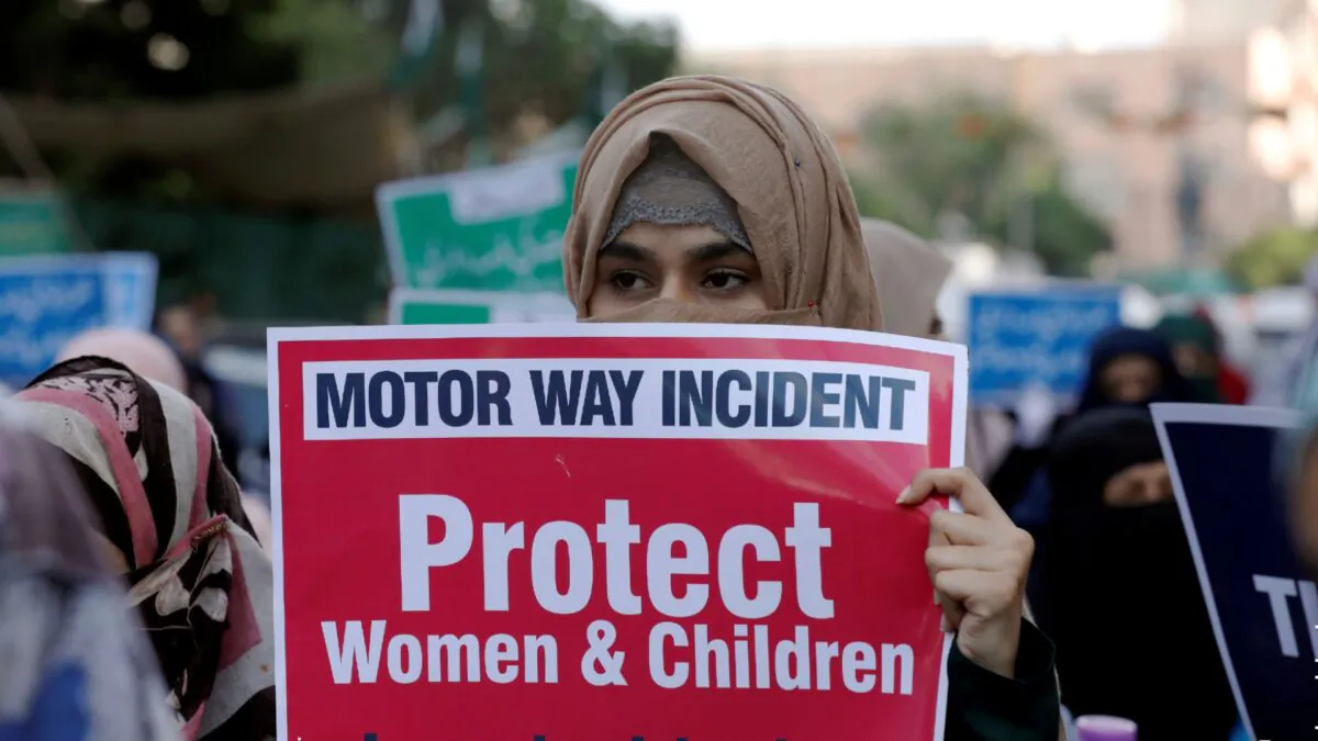 A supporter of religious and political party Jamaat-e-Islami (JI) carries a sign against a gang rape that occurred along a highway, and to condemn the violence against women and girls, during a demonstration in Karachi, Pakistan,  Sept. 11, 2020. (Akhtar Soomro/Reuters, File)
