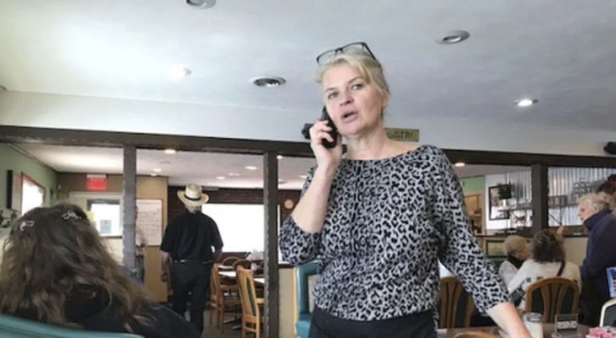 Marlena Pavlos-Hackney talks on a cell phone at her restaurant Marlena's Bistro & Pizzeria, in Holland, Mich., on March 18, 2021. Michigan State Police arrested Pavlos-Hackney on March 19, 2021. (John Agar/The Grand Rapids Press via AP)