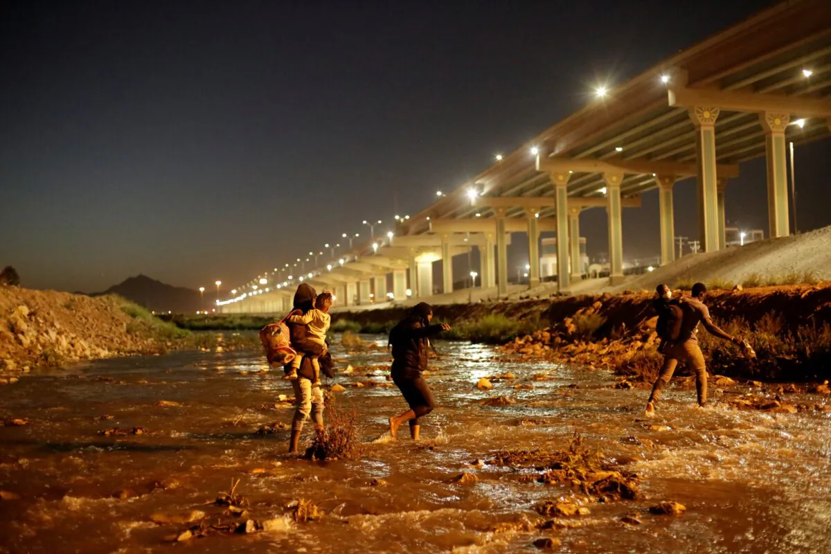Illegal immigrants cross the Rio Bravo river in El Paso, Texas, on March 19, 2021. (Jose Luis Gonzalez/Reuters)