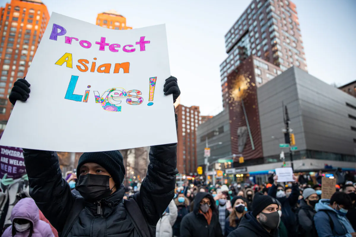 People attend the Peace Vigil for Victims of Asian Hate at Union Square Park in New York on March 19, 2021. (Chung I Ho/The Epoch Times)