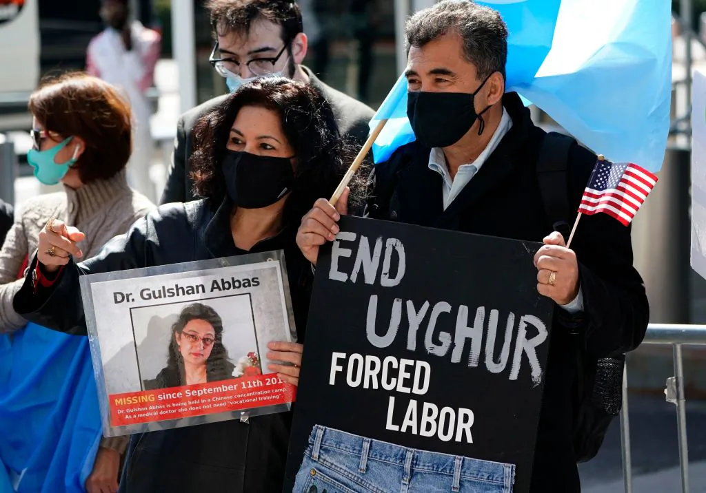 Protesters hold signs as they gather during Uyghur Freedom rally in New York on March 22, 2021. (Timothy A. Clary/AFP via Getty Images)