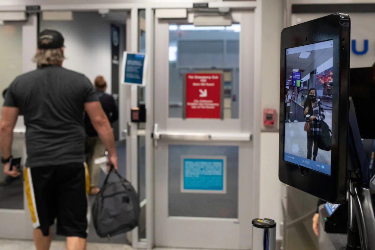 A passenger walks toward the airbridge as another walks up to use biometric boarding for an international flight United Airlines flight at IAH George Bush Intercontinental Airport in Houston, Texas, on July 21, 2020. (Adrees Latif/Reuters)